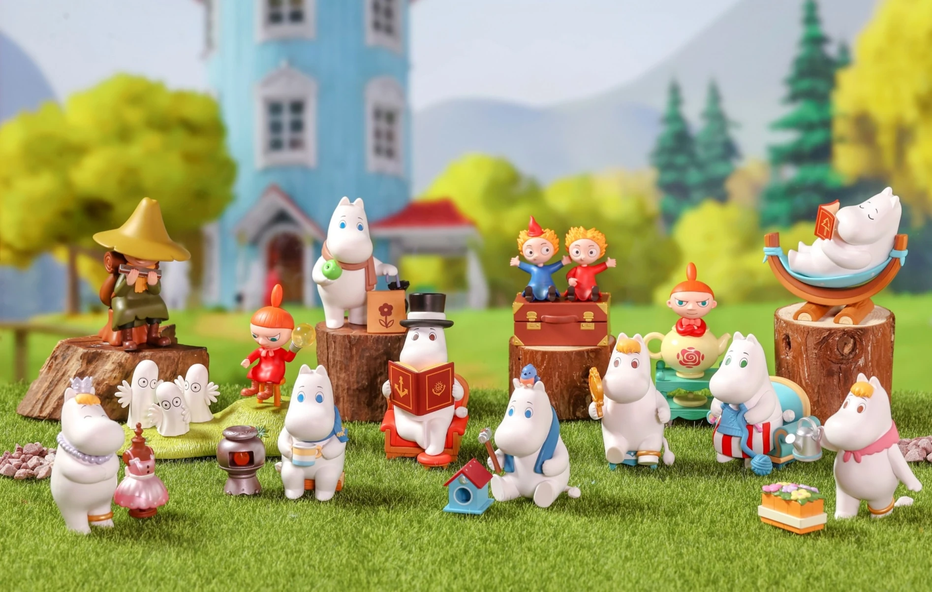 POP MART Moomin character figurines arranged in a miniature landscape