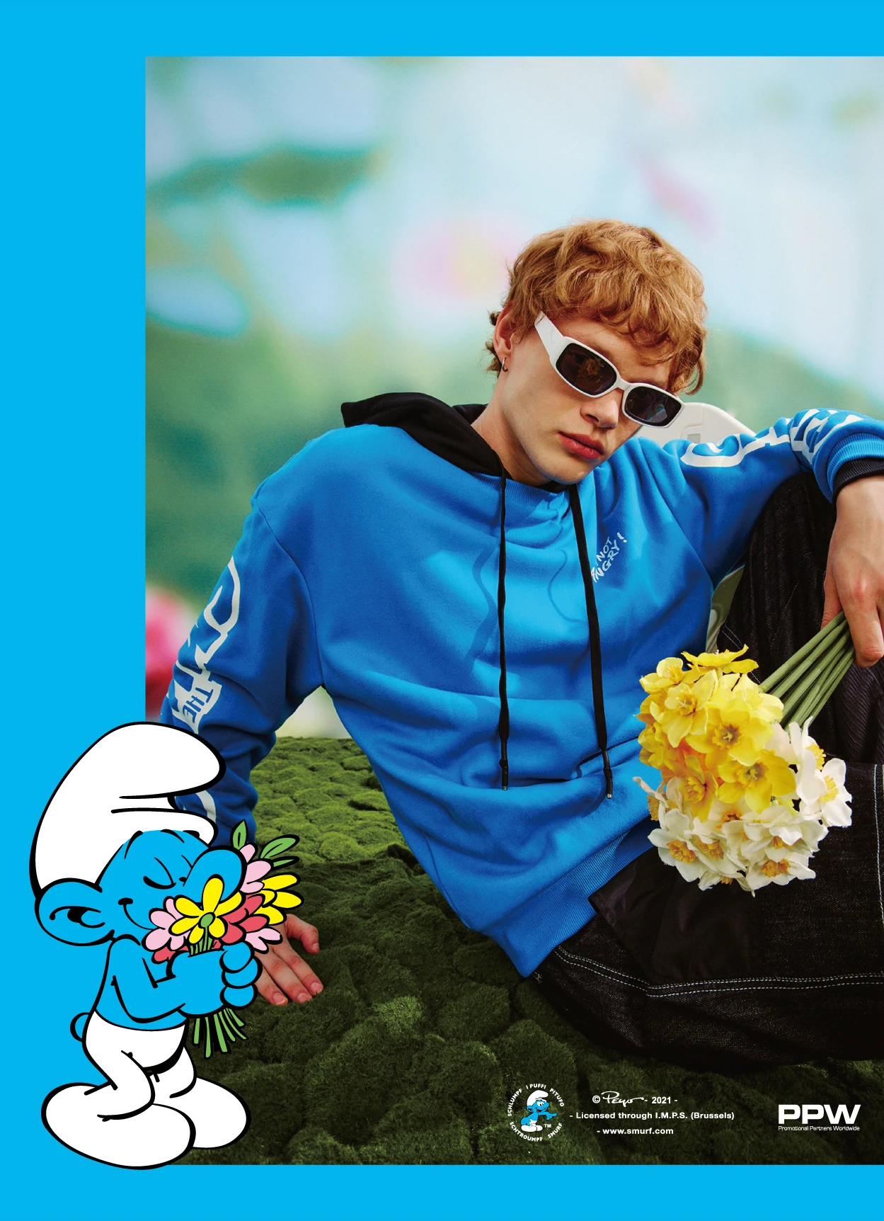 Teebox Smurfs campaign with a model in a blue sweatshirt