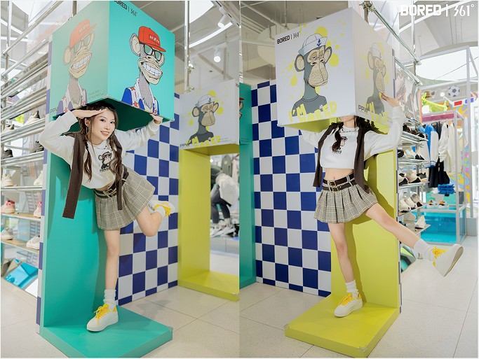 Visitors posing among Bored of Directors character panels in the 361° store